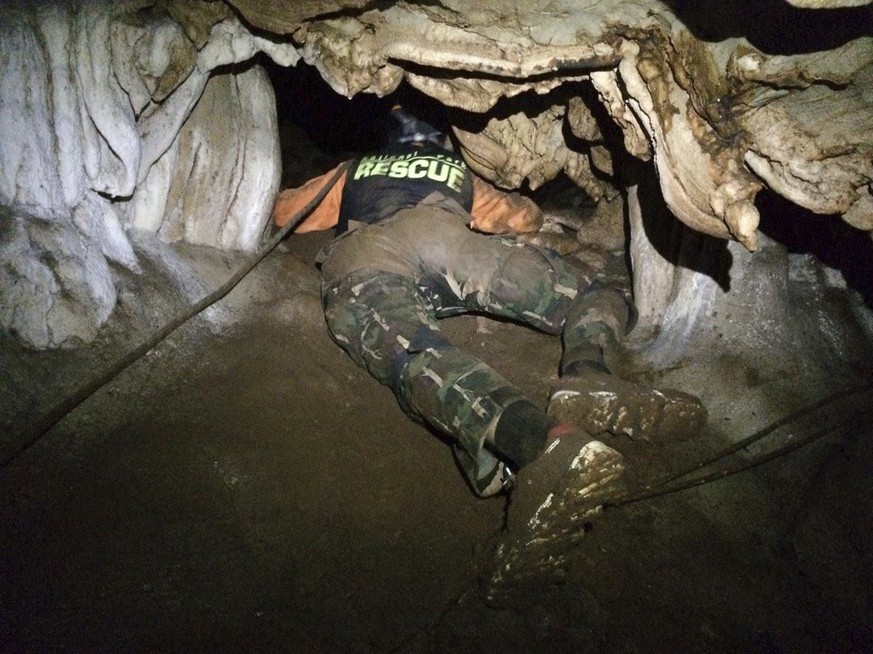 In this photo released by the Thailand Department of National Parks and Wildlife, Wednesday, June 27, 2018, rescue personnel search for alternate entrances to a cave where 12 boys of a soccer team and ...