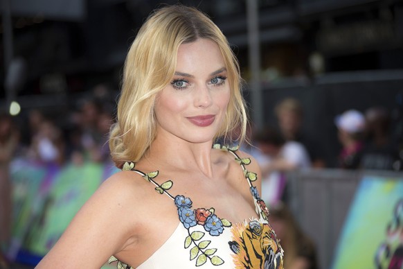 FILE - In this Aug. 3, 2016 file photo, actress Margot Robbie poses for photographers upon arrival at the European Premiere of &quot;Suicide Squad,&quot; in London. Robbie will host the season premier ...