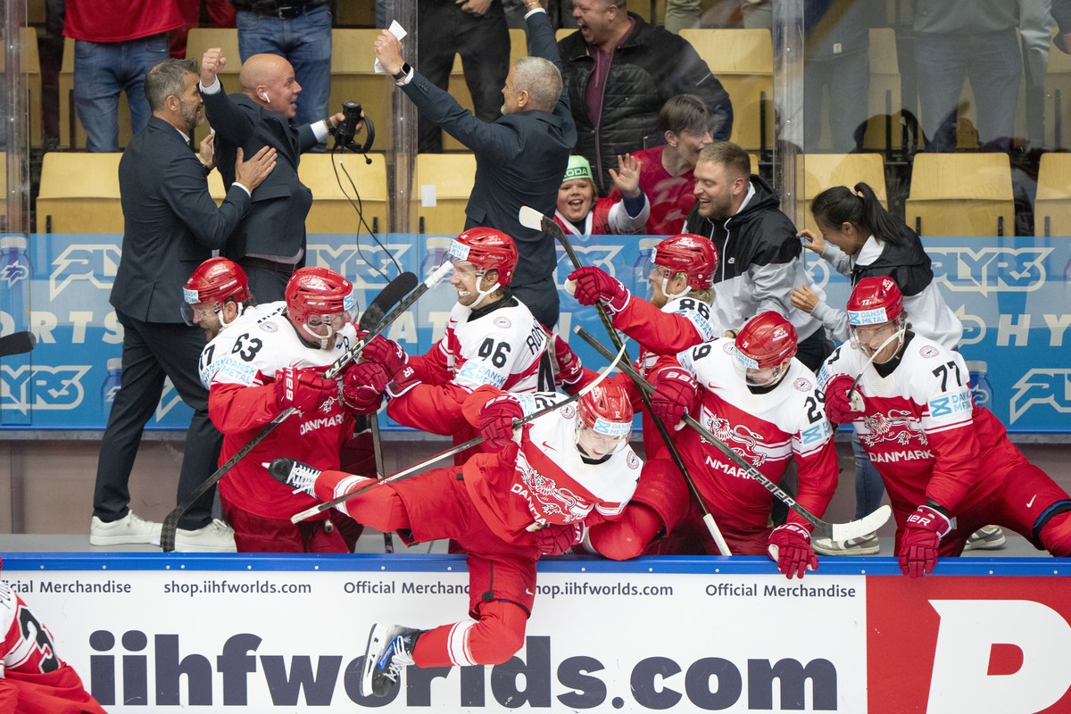 Denmark's head Mikael Gath, rear center, his staff, and players react after their 2-1 win in a quarterfinal game between Canada and Denmark at the hockey world championships, Thursday, May 22, 20 ...