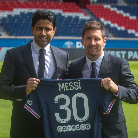 epa09409578 Paris Saint-Germain&#039;s president Nasser Al-Khelaifi (L) and Argentinian striker Lionel Messi pose with his new PSG jersey after his press conference as part of his official presentatio ...