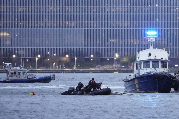 Divers exit the water after investigating the scene where a helicopter crashed into the Hudson River, Thursday, April 10, 2025, in Jersey City, N.J. (AP Photo/Seth Wenig)
NYC Helicopter Crash