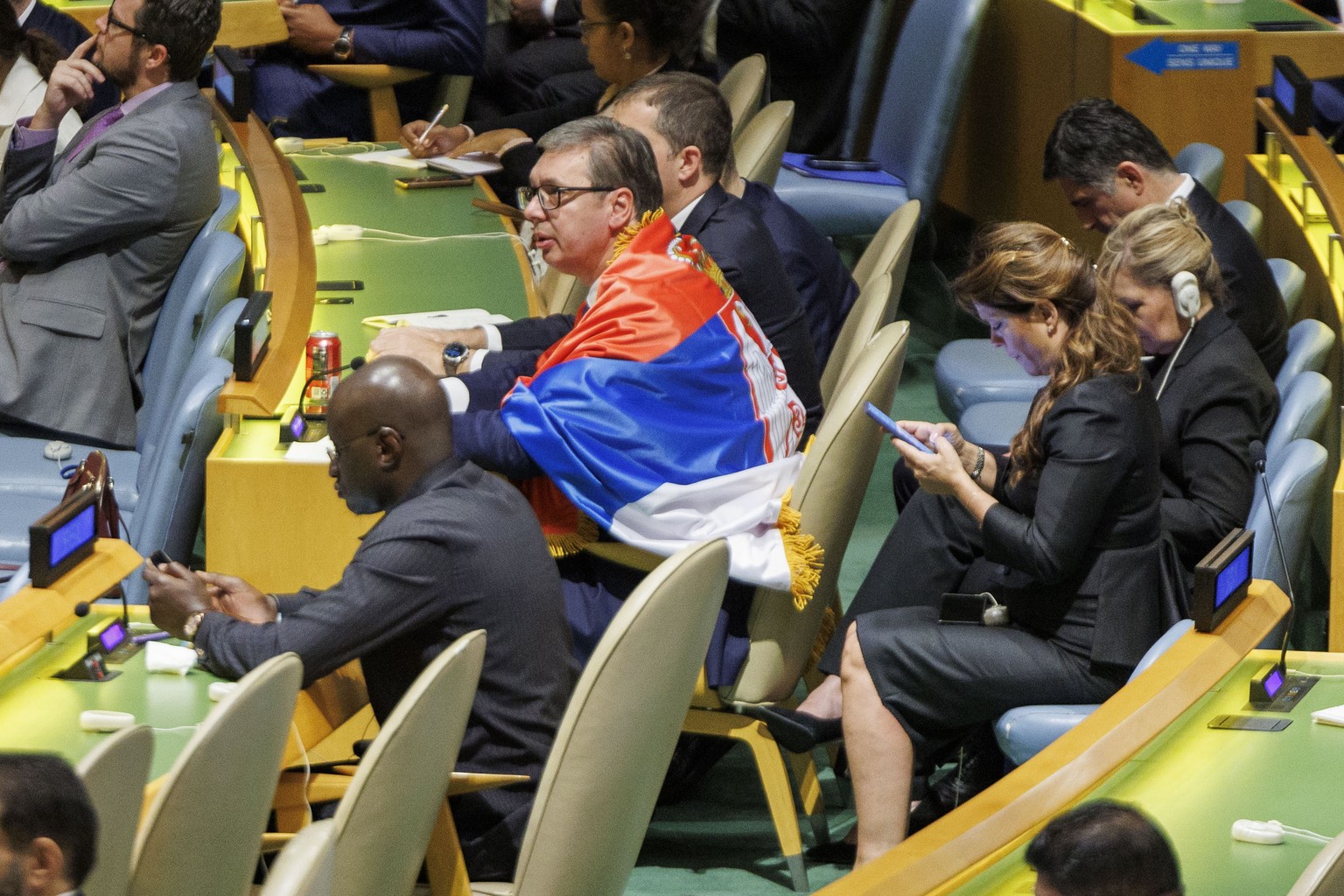 epa11363536 President of the Republic of Serbia Aleksandar Vucic wears a Serbian flag after the General Assembly voted and passed a resolution to create an International Day of Remembrance for victims ...