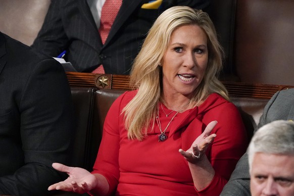 FILE - Rep. Marjorie Taylor Greene, R-Ga., talks as President Joe Biden delivers his first State of the Union address to a joint session of Congress, at the Capitol in Washington on March 1, 2022. A f ...