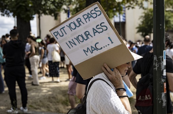 epa09362512 Thousands of protesters gather at Place Trocadero near the Eiffel Tower during a demonstration against the COVID-19 sanitary pass which grants vaccinated individuals greater ease of access ...