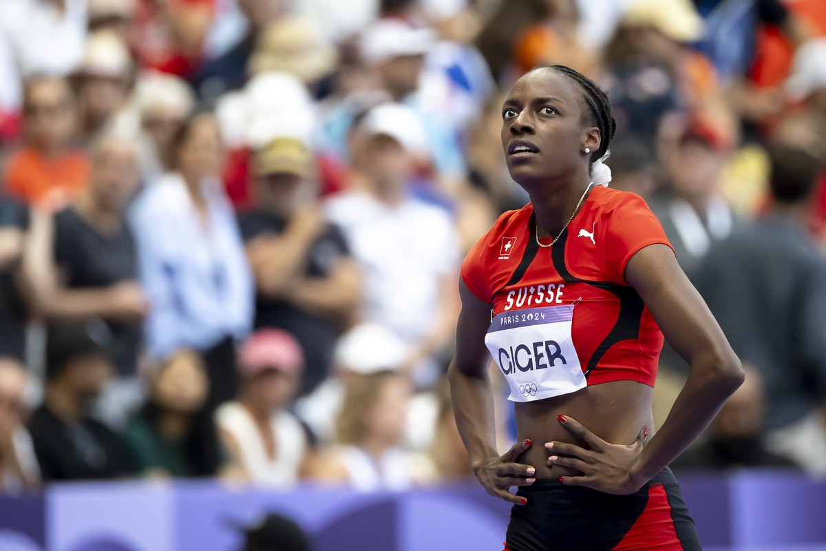 Yasmin Giger of Switzerland reacts after crossing the finish line during the women's 400m Hurdles Round 1 race at the 2024 Paris Summer Olympics in Paris, France, Sunday, August 4, 2024. (KEYSTON ...