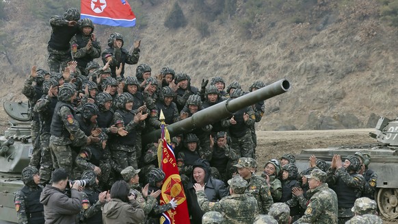 FILE - In this photo provided by the North Korean government, North Korean leader Kim Jong Un, center, meets soldiers who took part in a training in North Korea, on March 13, 2024. Independent journal ...