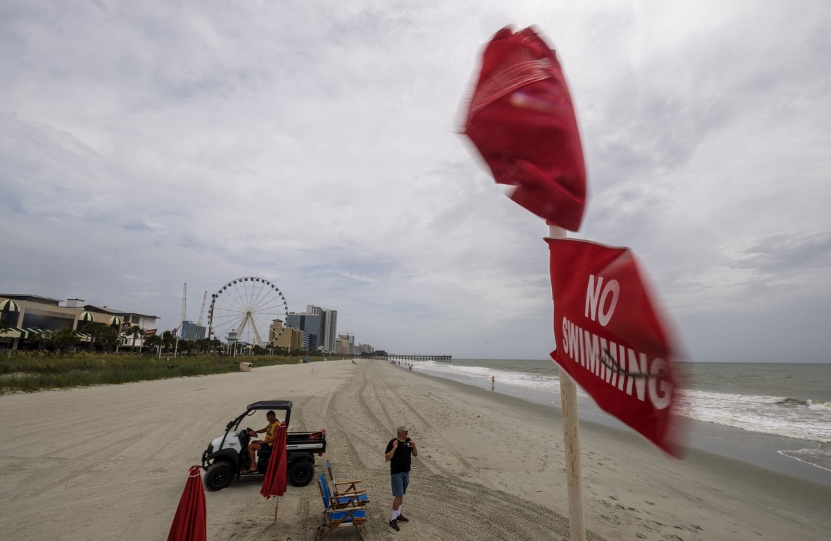 No swimming flags fly over a lifeguard stand in downtown Myrtle Beach, S.., on Monday, August 3, 2020. Tropical Storm Isaias is moving up the east coast and is expected to make landfall near Myrtle Be ...