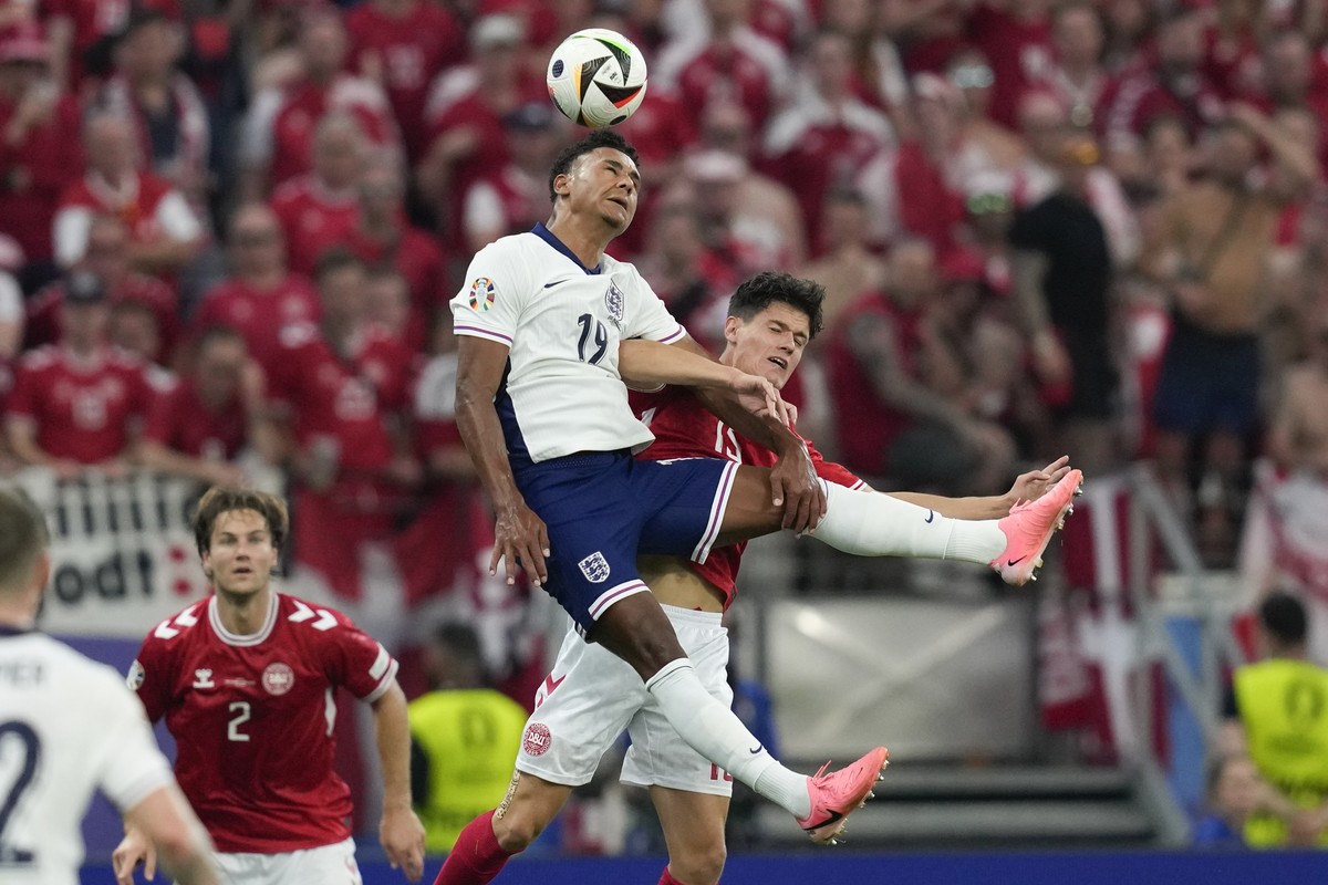 England's Ollie Watkins, top, heads the ball challenged by Denmark's Christian Norgaard during a Group C match between Denmark and England at the Euro 2024 soccer tournament in Frankfurt, Ge ...