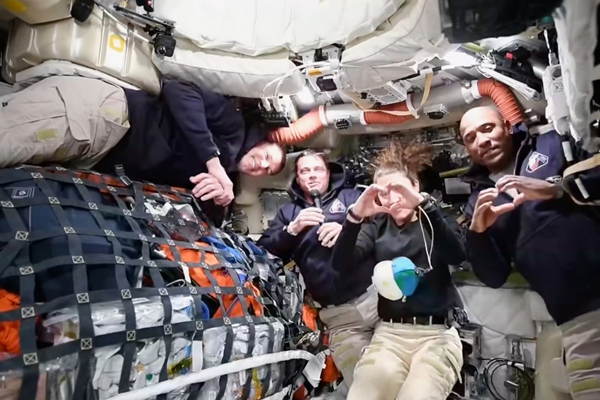 This image taken from video provided by NASA shows the Artemis II crew Commander Reid Wiseman, second from left, thanking the families of the crew while speaking with NASA Mission Control via video co ...