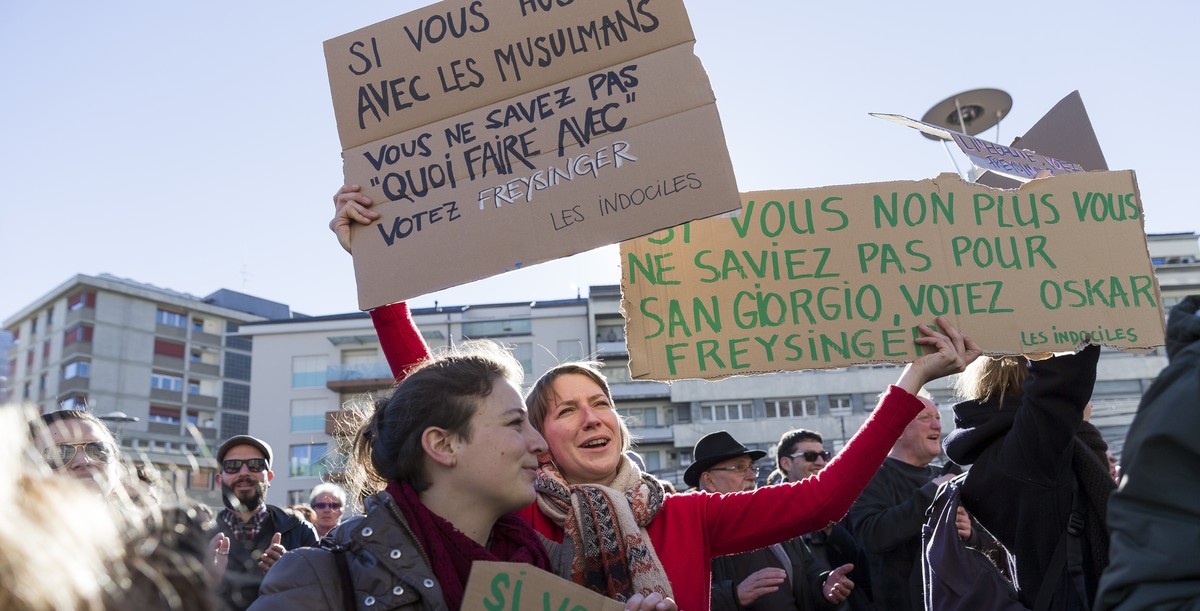 Des personnes manifestent pour protester contre une affiche de la campagne UDC de l'initiative "Le Valais d'abord" en vue des elections cantonales ce samedi, 18 fevrier 2017 a Sion ...