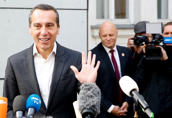 epa06266798 Austrian Chancellor and head of the Social Democratic Party (SPOe) Christian Kern answers media questions after casting his vote in the Austrian Federal Elections in Vienna, Austria, 15 Oc ...