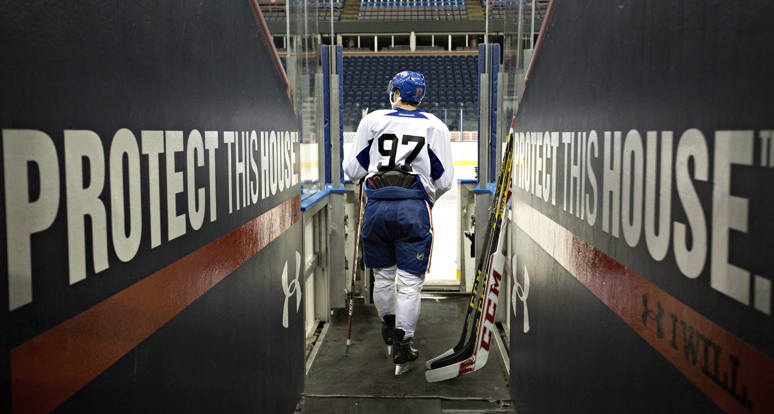 Edmonton Oilers first round pick Connor McDavid walks out to the ice for the Edmonton Oilers orientation camp in Edmonton, Alberta, Thursday, July 2, 2015. (Jason Franson/The Canadian Press via AP)