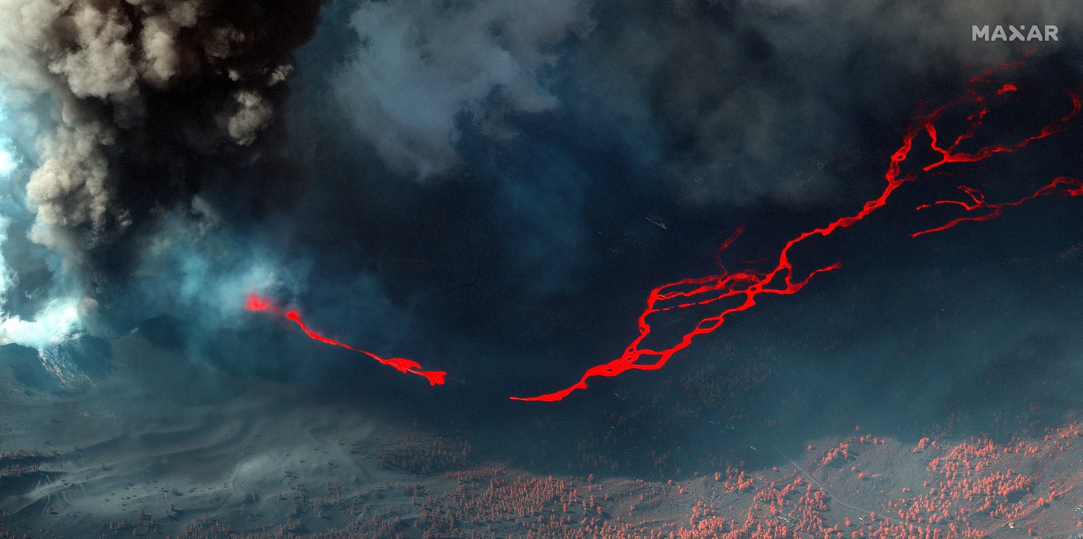epa09524201 A handout satellite image made available by Maxar Technologies shows an infrared color picture of lava produced by Cumbre Vieja volcano in La Palma island, Canary Islands, Spain, 14 Octobe ...