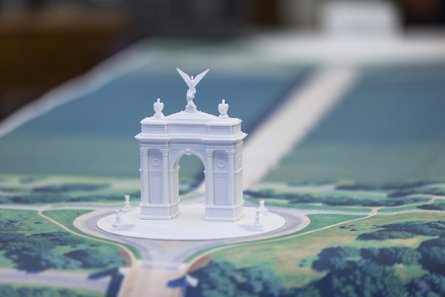 epa12456685 A model of the Triumph Arch across the Memorial Bridge from the Lincoln Memorial is seen on the Resolute Desk as US President Donald Trump (not pictured) responds to a question from the ne ...