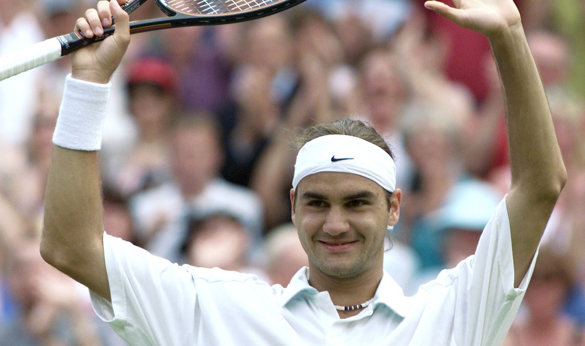 Roger Federer of Switzerland salutes the crowd, after defeating defending champion Pete Sampras in their men's singles, fourth round match on the Centre Court at Wimbledon, Monday July 2, 2001. F ...