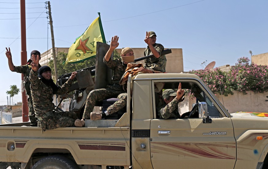 epa07251367 (FILE) - Members of Kurdish People Defence Units (YPG) flash victory sign after coming from Syrian town of al-Raqqa, in Tel Abyad, Syria, 23 June 2015 (Reissued 28 December 2018). Accordin ...