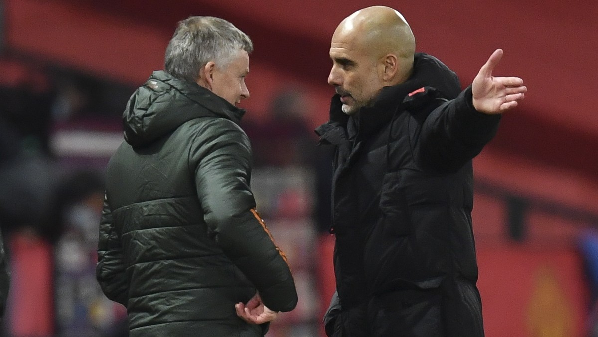 epa08880268 Manchester United's manager Ole Gunnar Solskjaer (L) and Manchester City manager Pep Guardiola (R) talk after the English Premier League soccer match between Manchester United and Man ...