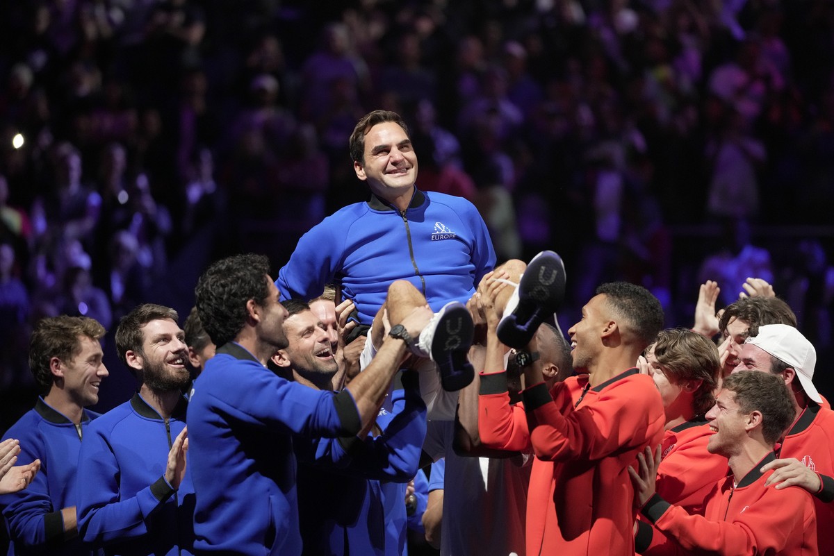 Team Europe's Roger Federer is lifted by fellow players after playing with Rafael Nadal in a Laver Cup doubles match against Team World's Jack Sock and Frances Tiafoe at the O2 arena in Lond ...