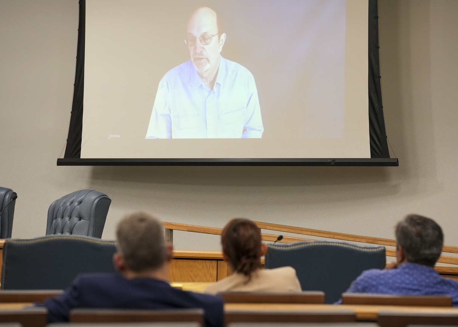 Steven Ross, former OceanGate scientific director, top, speaks via video link as he testifies during the Titan marine board formal hearing inside the Charleston County Council Chambers, Thursday, Sept ...
