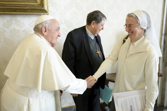 This image released on Wednesday Jan. 8, 2025 by the Vatican Media shows Pope Francis shaking hands with Sister Simona Brambilla, an Italian nun who is the first woman named to head a major Vatican of ...
