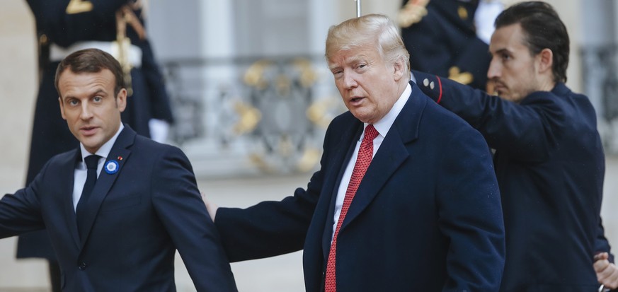 French President Emmanuel Macron, left, greets President Donald Trump prior to their meeting at the Elysee presidential palace, in Paris, Saturday, Nov. 10, 2018. Trump is joining other world leaders  ...