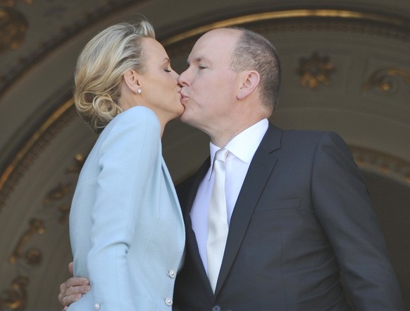 Prince Albert II of Monaco kisses his bride Charlene Princess of Monaco at the Monaco palace, after the civil wedding marriage ceremony, Friday, July 1, 2011. (AP Photo/Bruno Berbert, Pool)