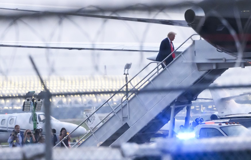 epaselect epa10819008 Former US President Donald Trump boards his plane at Hartsfield Jackson Atlanta International Airport after turning himself into authorities at the Fulton County Jail following a ...