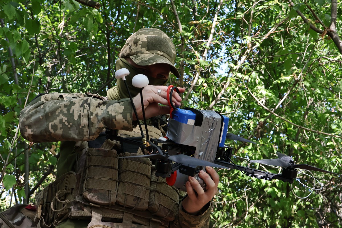 In this photo provided by Ukraine's 65th Mechanized Brigade press service, a Ukrainian soldier prepares an FPV drone to fire towards Russian positions in Zaporizhzhia region, Ukraine, Saturday, S ...
