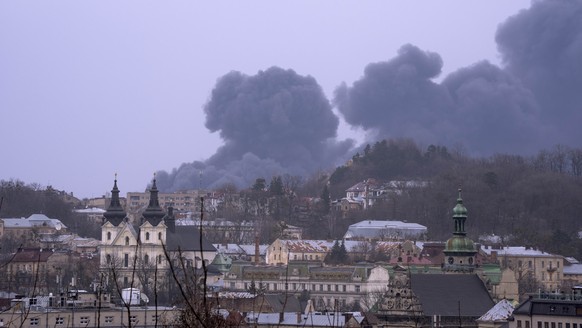 Smoke rises the air in Lviv, western Ukraine, Saturday, March 26, 2022. With Russia continuing to strike and encircle urban populations, from Chernihiv and Kharkiv in the north to Mariupol in the sout ...
