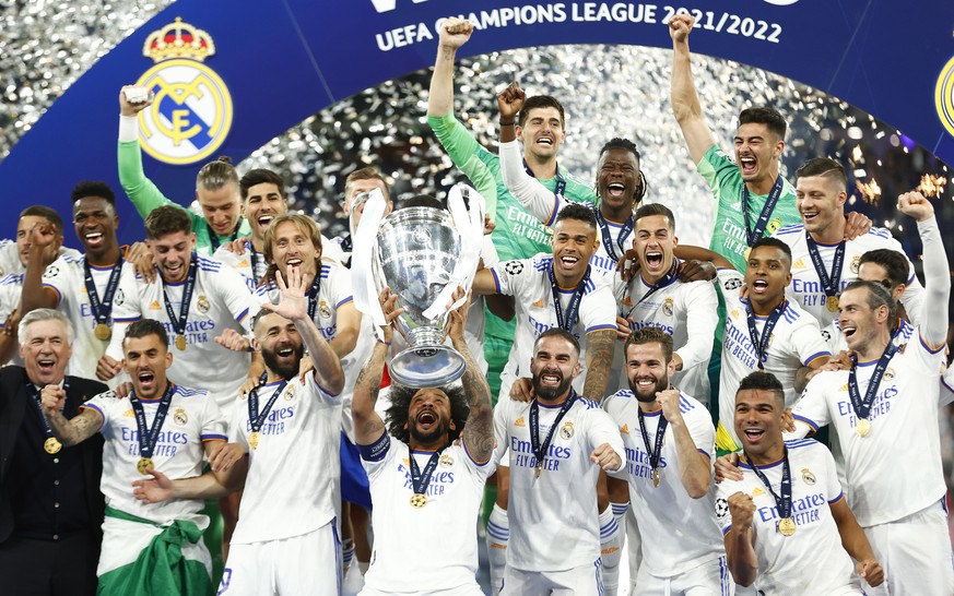 epa09983404 Marcelo (C) of Real Madrid lifts the trophy as his teammates celebrate after winning the UEFA Champions League final between Liverpool FC and Real Madrid at Stade de France in Saint-Denis, ...