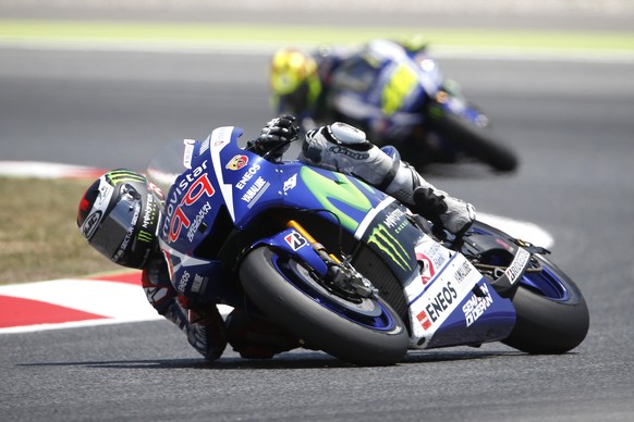 Moto GP rider Jorge Lorenzo of Spain, steers his motorcycle as he is followed by Valentino Rossi of Italy, during the Catalunya Motorcycle Grand Prix at the Barcelona Catalunya racetrack in Montmelo, near Barcelona, Spain, on Sunday, June 14, 2015. (AP Photo/Manu Fernandez)