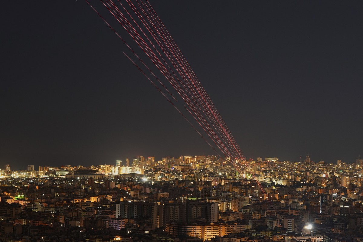 Tracer rounds light the sky as people fire live rounds into the air during a televised speech by Hezbollah leader Naim Kassem in Dahiyeh, Beirut's southern suburbs, Lebanon, Wednesday, March 4, 2 ...