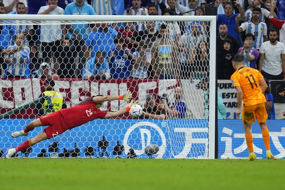 Argentina's goalkeeper Emiliano Martinez saves a kick of Steven Berghuis of the Netherlands during penalty shootout the World Cup quarterfinal soccer match between the Netherlands and Argentina,  ...