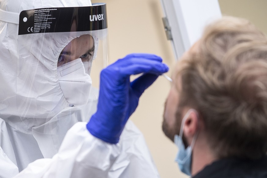 A man gets a nasal swab at the corona test center at Central Station in Cologne, Germany, Friday, Oct. 23, 2020. According to the Robert Koch Institute, Germany&#039;s federal government agency and re ...