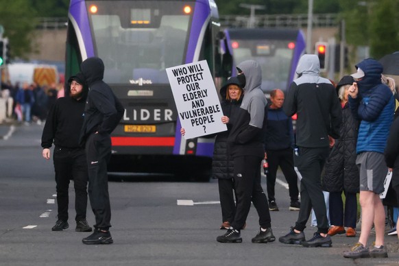 A crowd of protesters gathers in the road following a stabbing incident in North Belfast, Tuesday, June 9, 2026. (AP Photo/Peter Morrison)
Britain Northern Ireland Stabbing