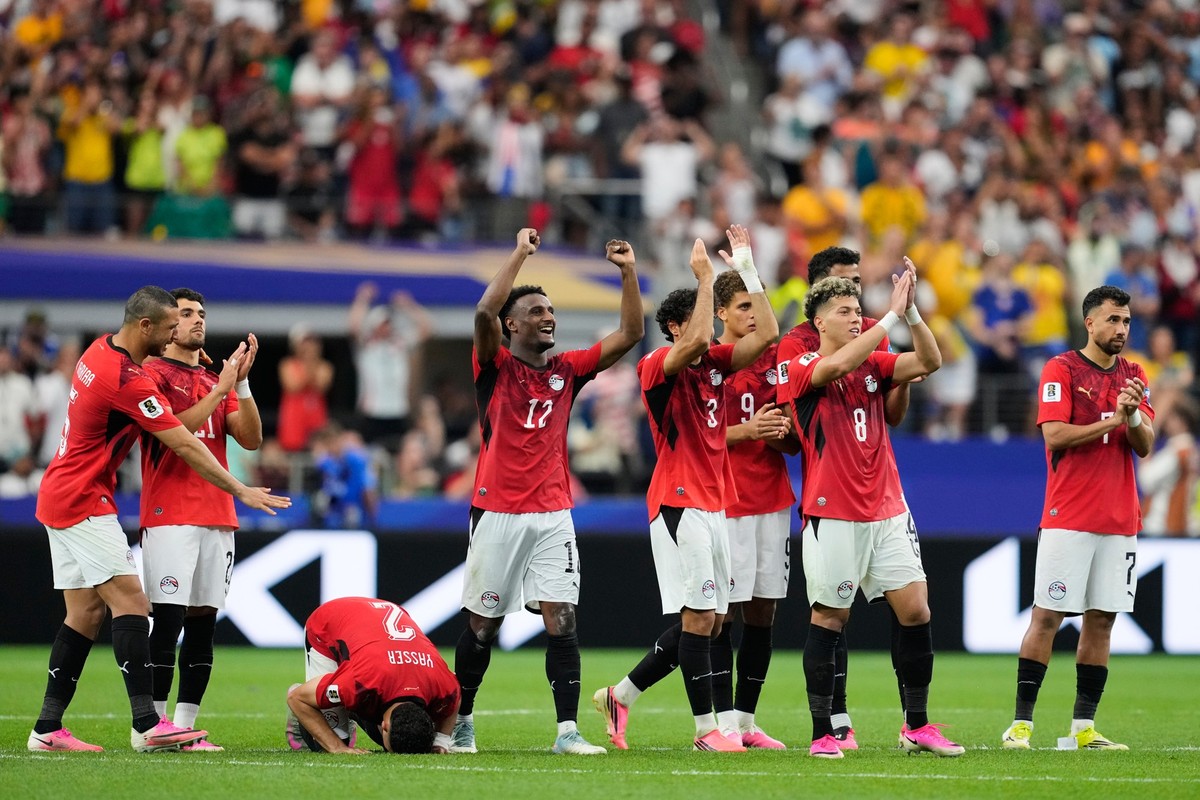 Egypt players react to teammate Mohamed Salah scoring during a penalty shootout against Australia for the World Cup round of 32 soccer match in Arlington, Texas, near Dallas, Friday, July 3, 2026. (AP ...