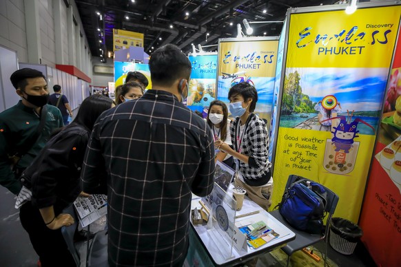 epa08643179 Tour operators for Phuket show options to customers at a domestic travel fair in Bangkok, Thailand, 03 September 2020. National travel has seen an increase in July as more people take adva ...
