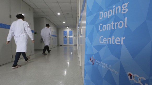 Researches enter into the Doping Control Center at the Korea Institute of Science and Technology in Seoul, South Korea, Monday, Feb. 19, 2018. Russia could lose its chance to be reinstated before the end of the Winter Olympics because of a doping charge against curling bronze medalist Alexander Krushelnitsky. (AP Photo/Ahn Young-joon)