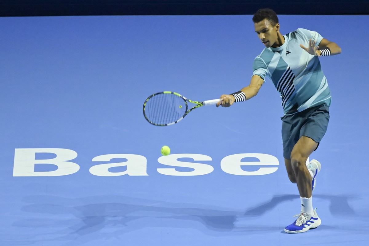 Canada's Felix Auger-Aliassime returns a ball to Switzerland's Leandro Riedi during their first round match at the Swiss Indoors tennis tournament at the St. Jakobshalle in Basel, Switzerlan ...