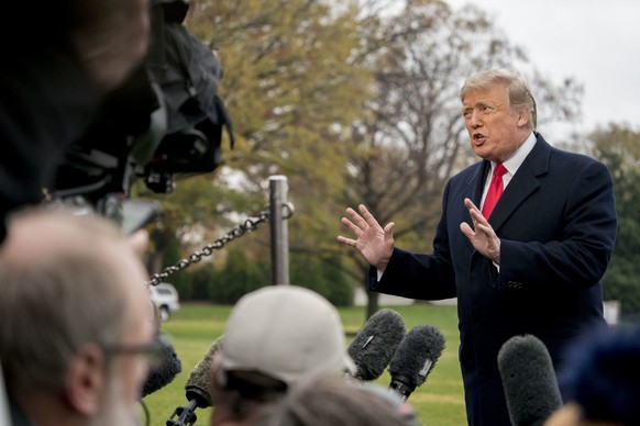 In this Nov. 26, 2018, photo, President Donald Trump speaks to members of the media before boarding Marine One on the South Lawn of the White House in Washington. Trump has moved steadily to dismantle ...