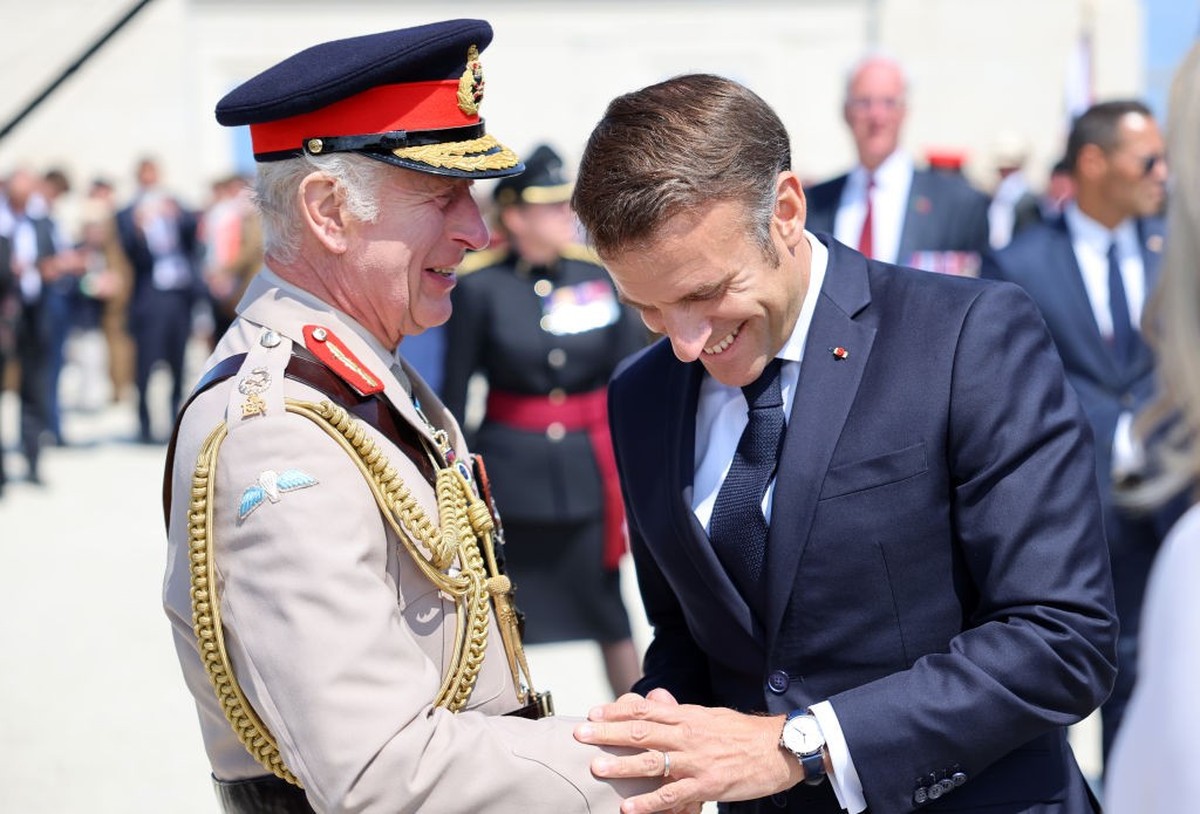 VER-SUR-MER, FRANCE - JUNE 06: King Charles III and President of France, Emmanuel Macron laugh during the UK Ministry of Defence and the Royal British Legion’s commemorative event at the British Norma ...