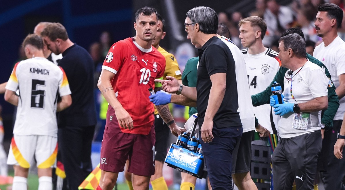 FRANKFURT AM MAIN, GERMANY - JUNE 23: Granit Xhaka of Switzerland L talks to head coach Murat Yakin of Switzerland R during the UEFA EURO, EM, Europameisterschaft,Fussball 2024 group stage match betwe ...