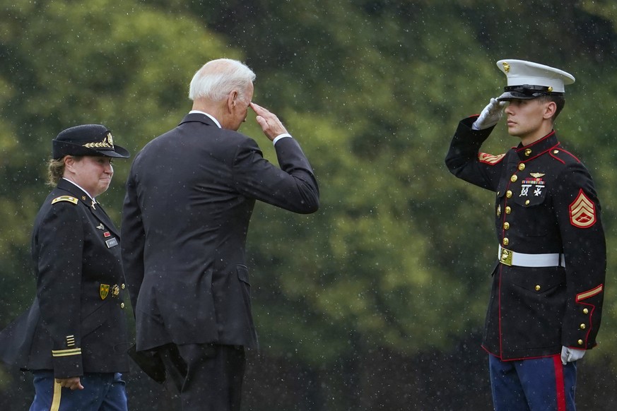 President Joe Biden returns a salute as he walks to board Marine One at Fort Lesley J. McNair in Washington, Monday, Aug. 16, 2021, en route to Camp David after addressing the nation from the White Ho ...