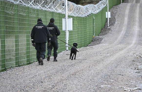 epa10939909 Finnish border guards patrol the border fence, in Imatra, Finland, October 26, 2023. The Finnish border guards have started building a border fence on Finland's eastern border with Russia...