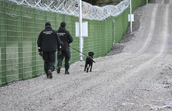 epa10939909 Finnish border guards patrol the border fence, in Imatra, Finland, 26 October 2023. The Finnish Border Guard has started building a border fence on Finland&#039;s eastern border with Russi ...