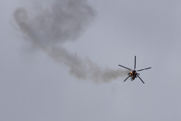FILE - In this Feb. 11, 2020, file photo, Syrian government helicopter is shot by a missile in Idlib province, Syria. SyriaÄôs civil war has long provided a free-for-all battlefield for proxy fighter ...