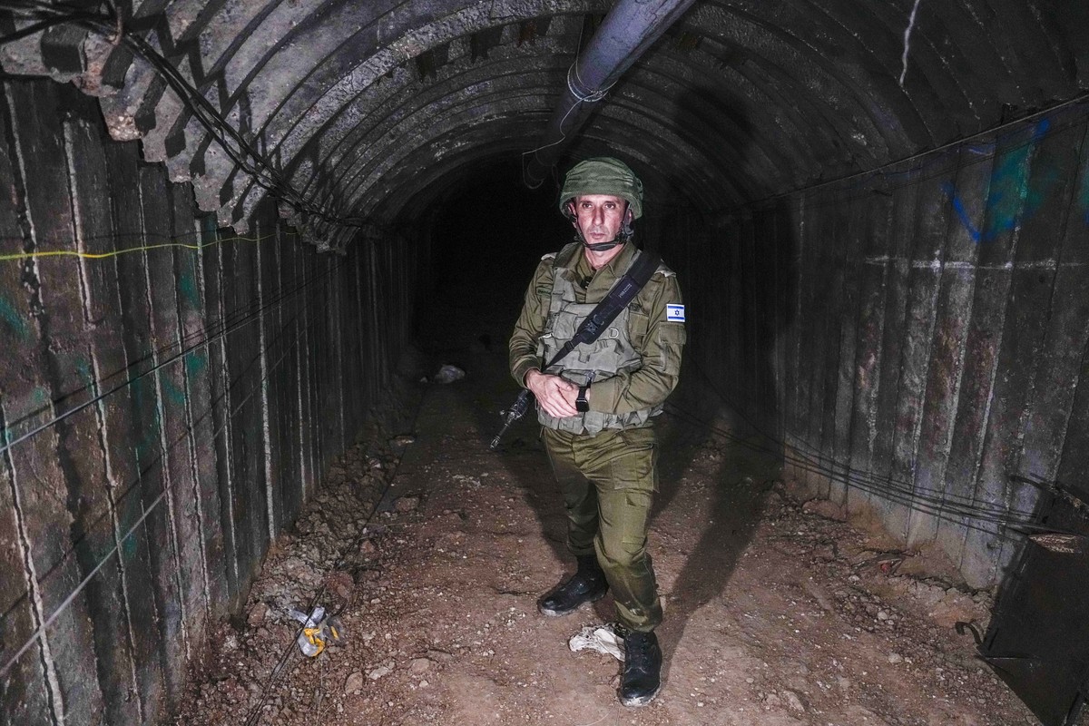 Israeli military spokesperson, Rear Adm. Daniel Hagari, speaks to the media in a tunnel that the military says Hamas militants used to attack the Erez crossing in the northern Gaza Strip, Friday, Dec. ...