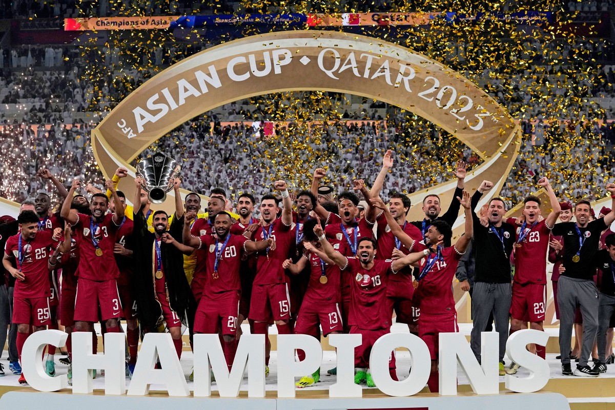 FILE - The Qatar team poses with the trophy at the end of the Asian Cup final soccer match between Qatar and Jordan at the Lusail Stadium in Lusail, Qatar, Feb. 10, 2024. (AP Photo/Thanassis Stavrakis ...