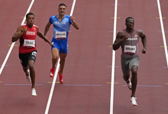 Aaron Brown, of Canada, Antonio Infantino, of Italy and William Reais, of Switzerland race in a men&#039;s 200-meter heat ahead of Shaun Maswanganyi, of South Africa at the 2020 Summer Olympics, Tuesd ...