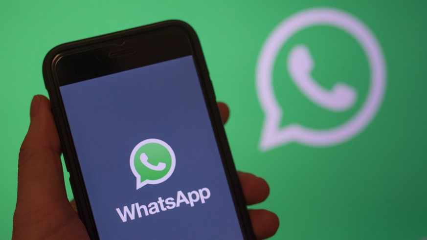 epa07568740 epa07306542 (FILE) - A smart phone screen shows the logo of WhatsApp application in Berlin, Germany, 31 December 2017 (reissued 14 May 2019). Facebook&#039;s messenger service WhatsApp has ...